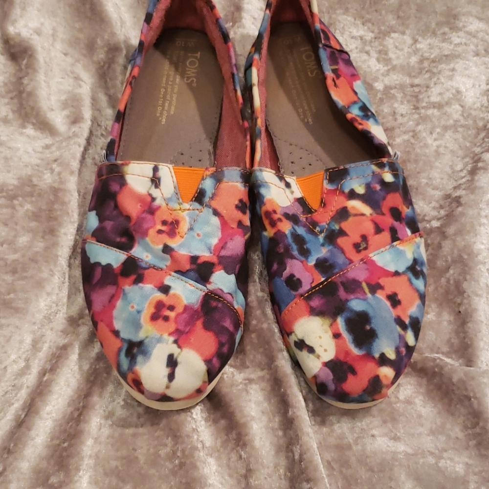 Toms Women's Floral Canvas Slip-Ons in Purple, Blue, Pink and Orange.